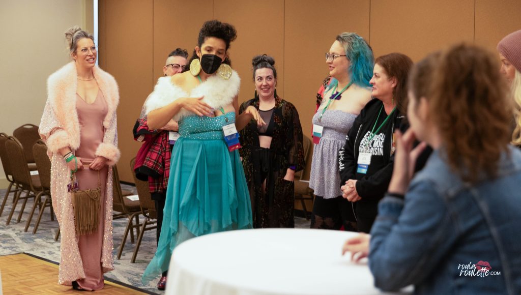 Executive Director Miss AuroraBoobRealis speaks to team members at BurlyCon, by Roula Roulette